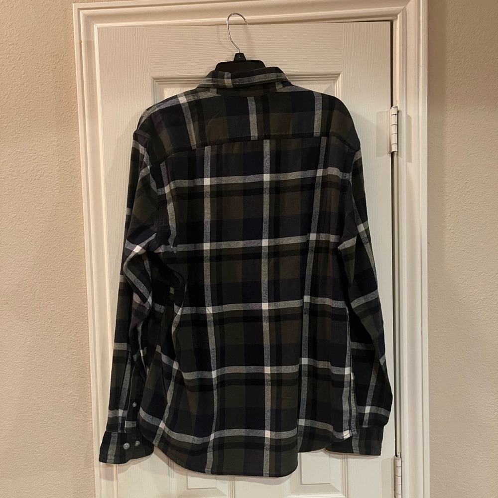Navy blue background plaid long sleeve button down flannel shirt.